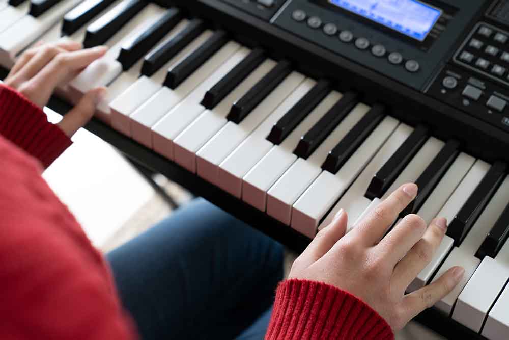 little girl hand playing piano keyboard
